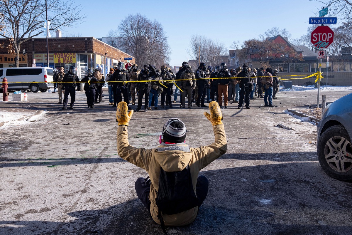 Law enforcement agents firing munitions with bright sparks during the Minneapolis protests