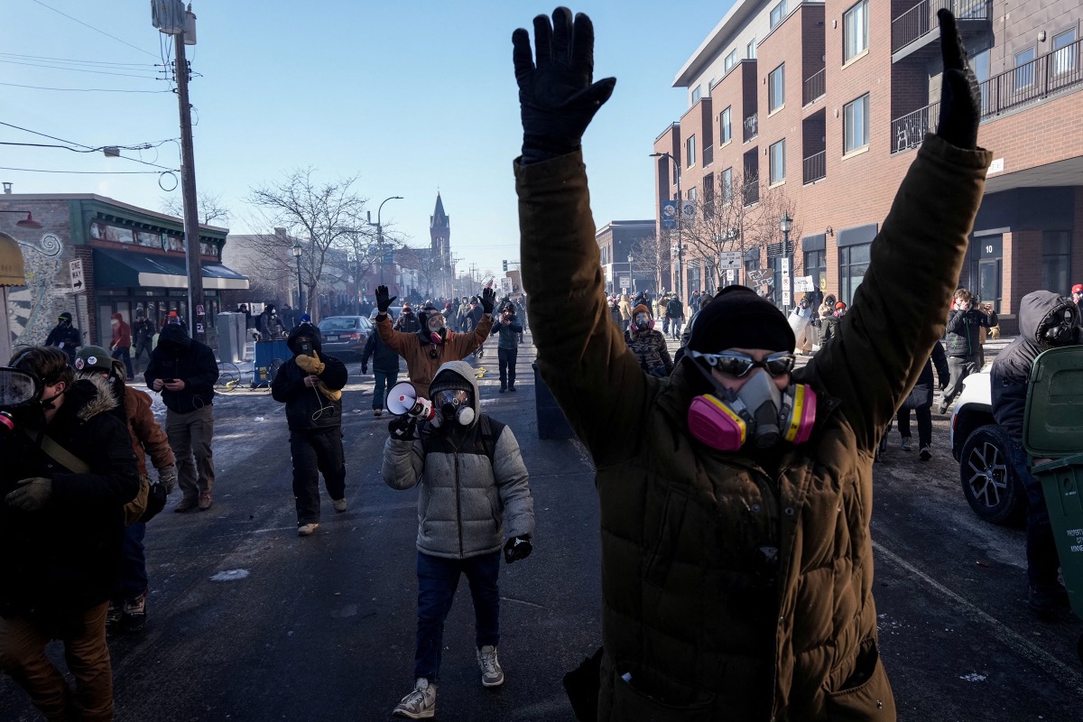 Large crowd of protesters carrying signs and marching during demonstrations in Minneapolis
