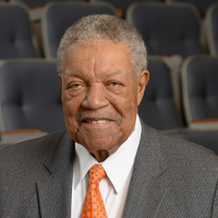 Robb Pitts, Chairman of the Fulton County Board of Commissioners, in an official portrait. He wears a gray suit with an orange tie.